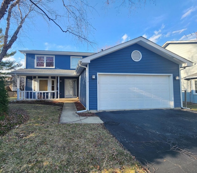view of front of property featuring a porch, driveway, and a garage