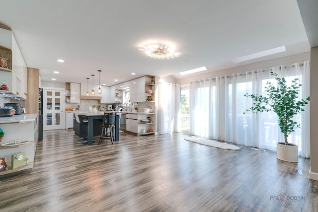 living area featuring wood finished floors and recessed lighting