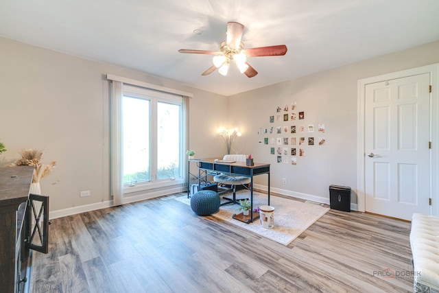 dining space with ceiling fan, wood finished floors, and baseboards