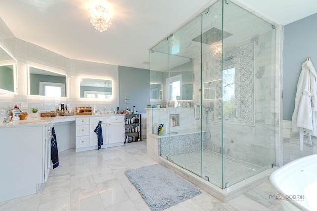 bathroom featuring an inviting chandelier, a stall shower, vanity, and marble finish floor