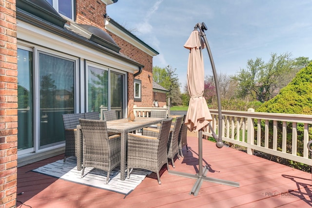 wooden terrace featuring outdoor dining space
