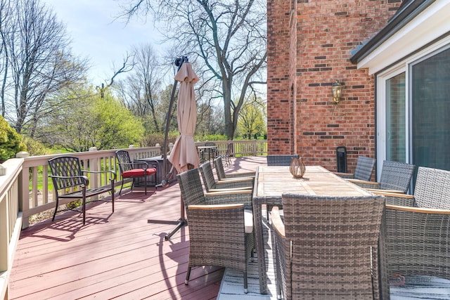 wooden terrace featuring outdoor dining space