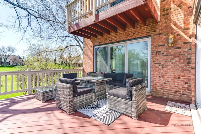 wooden terrace with an outdoor living space