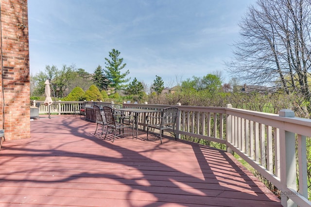 wooden terrace featuring outdoor dining area