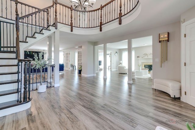 foyer entrance with wood finished floors, plenty of natural light, and stairs