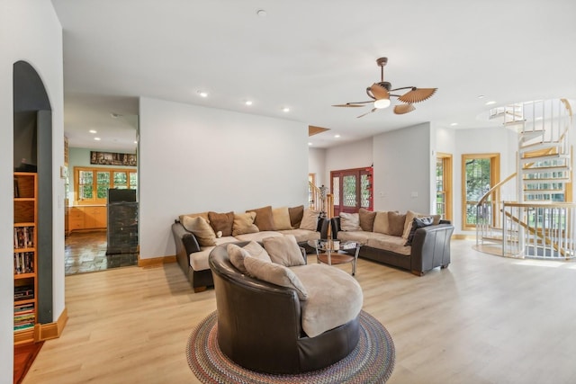 living area with light wood-style flooring, stairway, ceiling fan, and recessed lighting