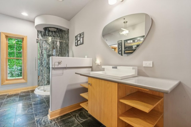 full bathroom featuring a shower stall, vanity, and baseboards
