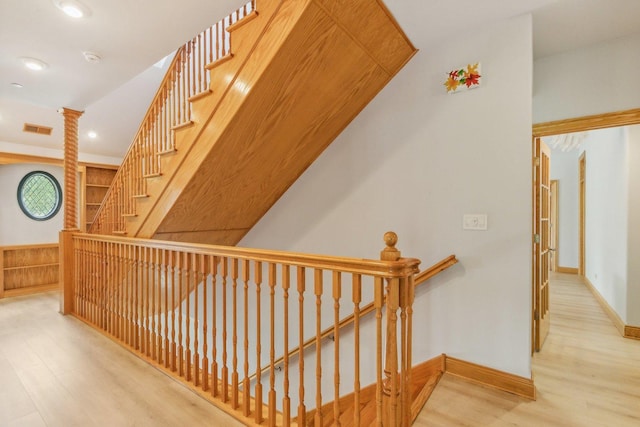 corridor featuring baseboards, recessed lighting, an upstairs landing, visible vents, and wood finished floors