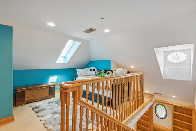 bonus room featuring recessed lighting, vaulted ceiling with skylight, visible vents, and wood finished floors