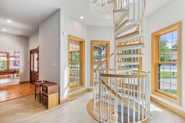 hall featuring visible vents, recessed lighting, wood finished floors, stairs, and baseboards