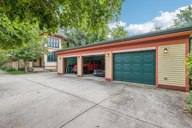 garage featuring concrete driveway