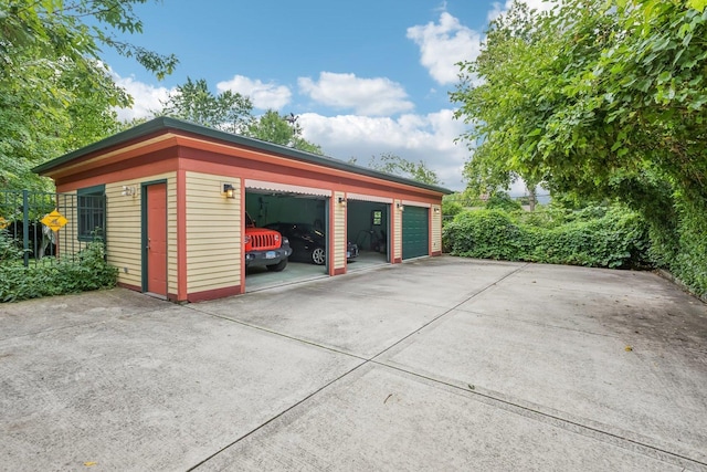 detached garage with concrete driveway