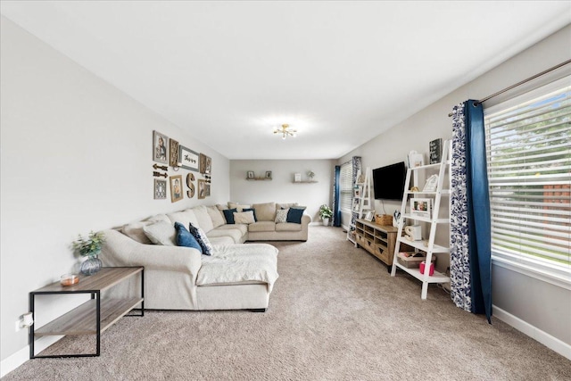 carpeted living room with baseboards
