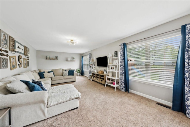 living area with carpet floors, baseboards, and visible vents