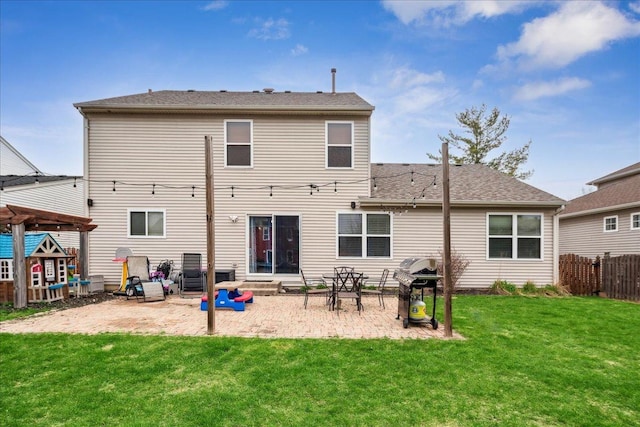 rear view of house with fence, a patio, and a yard