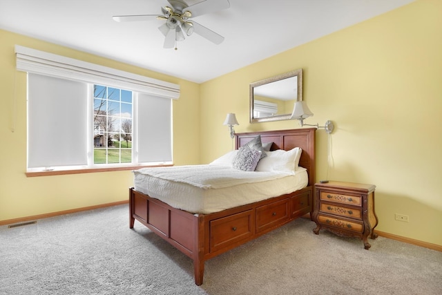 bedroom with visible vents, baseboards, a ceiling fan, and light colored carpet