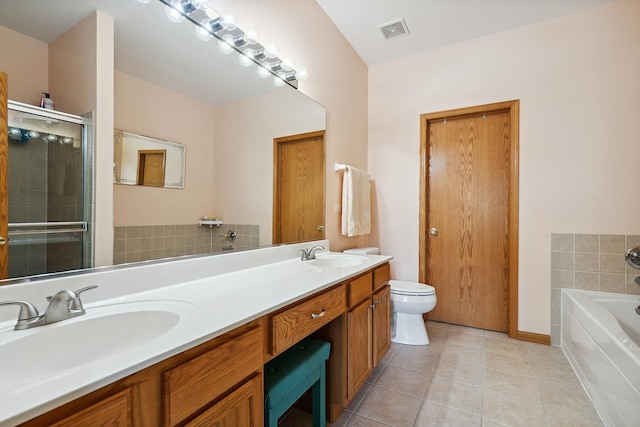 full bathroom featuring a sink, visible vents, tile patterned flooring, and a garden tub