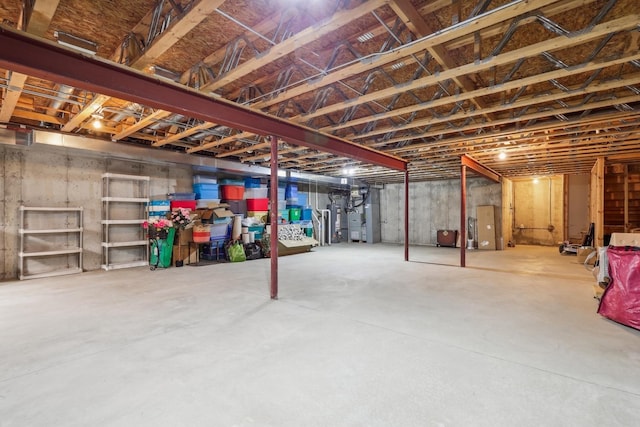 unfinished basement featuring heating unit