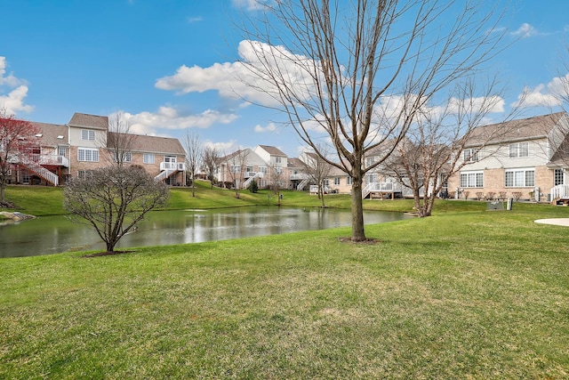 view of yard featuring a water view and a residential view