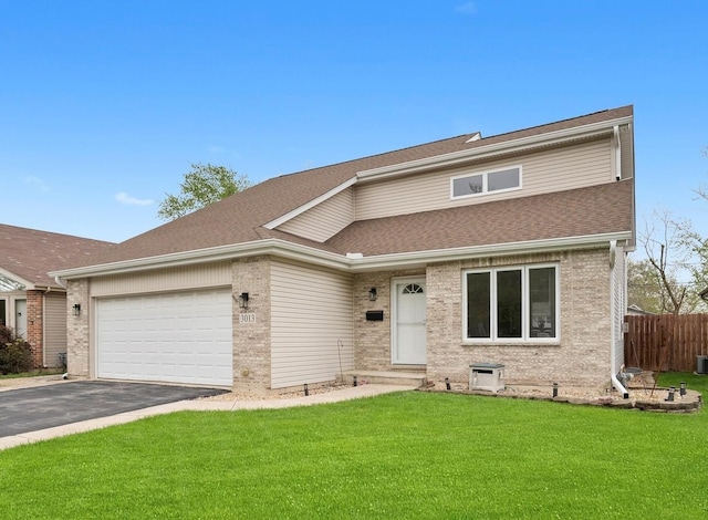 traditional-style home with an attached garage, driveway, a shingled roof, and brick siding
