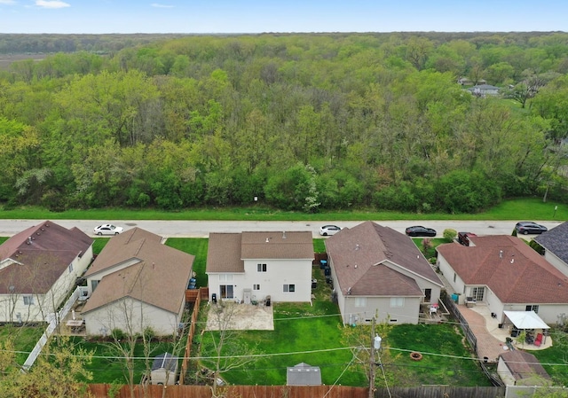 aerial view of residential area with a heavily wooded area