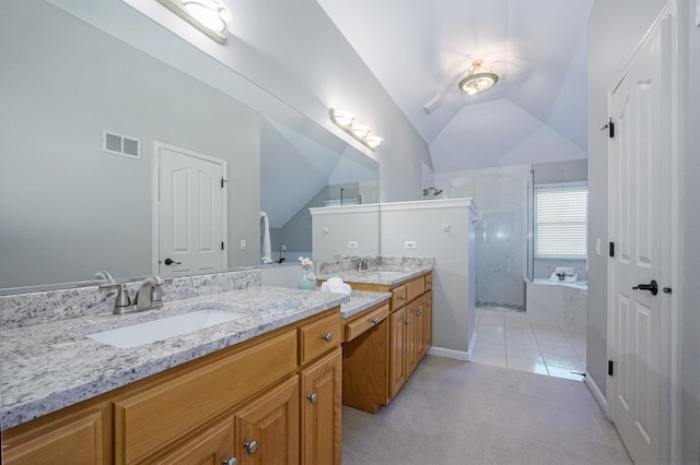 bathroom with a bath, double vanity, a sink, and visible vents