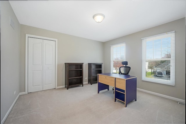 carpeted office space with visible vents and baseboards