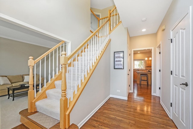 stairs featuring baseboards, recessed lighting, and wood finished floors