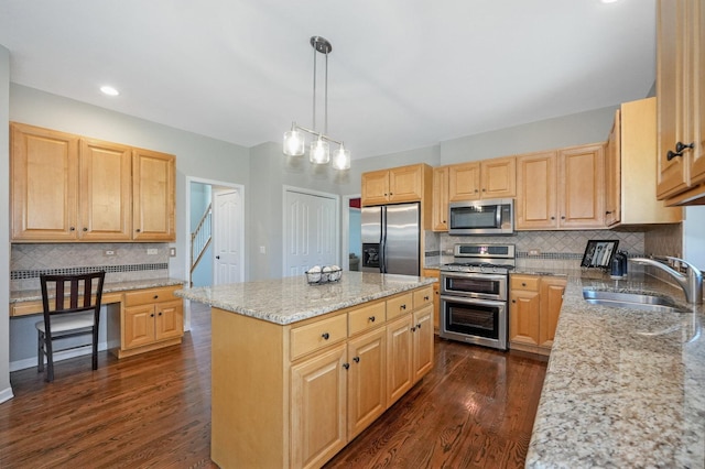 kitchen featuring light brown cabinets, a sink, dark wood finished floors, stainless steel appliances, and backsplash
