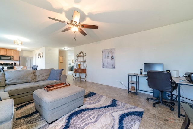 living room with ceiling fan and baseboards