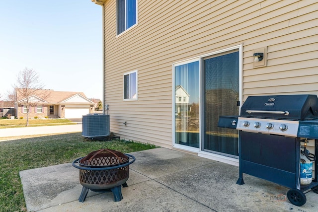 view of patio featuring a fire pit, area for grilling, and central AC unit