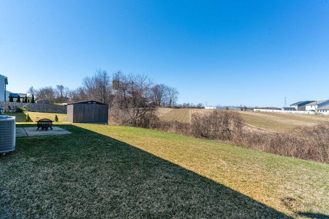 view of yard with a shed, central AC, and an outdoor structure