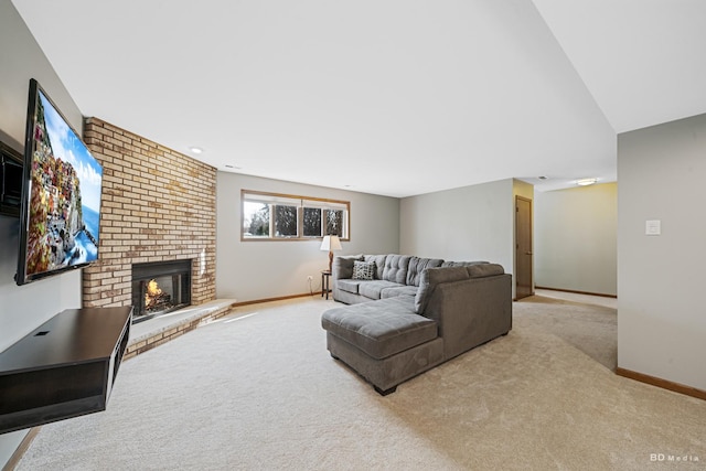 carpeted living area with baseboards and a brick fireplace