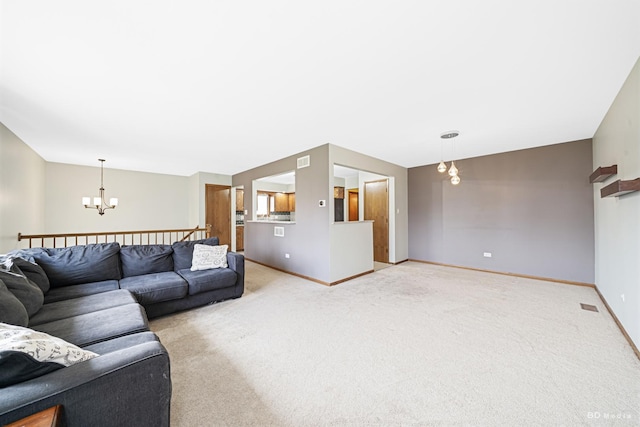 living area featuring light colored carpet, an inviting chandelier, and baseboards