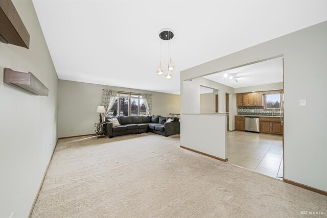 living room with light carpet, baseboards, and a wealth of natural light