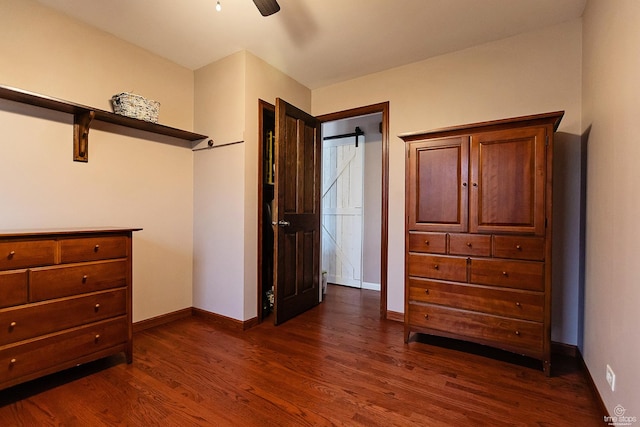 bedroom featuring a ceiling fan, baseboards, and dark wood finished floors