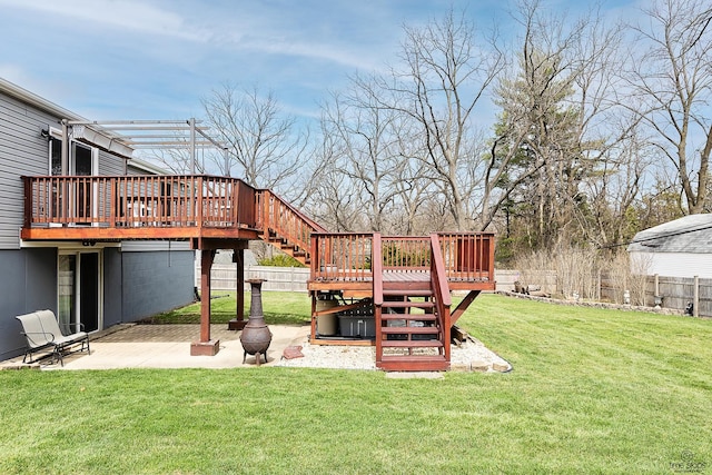 view of yard featuring a patio, a wooden deck, fence, and stairs