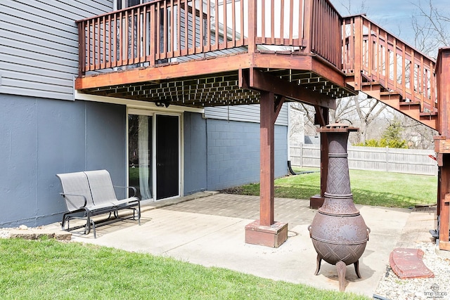 view of patio / terrace featuring an outdoor fire pit, a wooden deck, and fence
