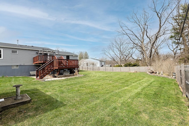 view of yard featuring a fenced backyard, a wooden deck, and stairs