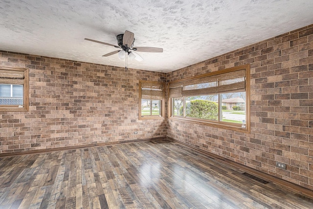 305 166th St, Calumet City, IL 60409 - empty room with brick wall, hardwood / wood-style floors, ceiling fan, and a textured ceiling