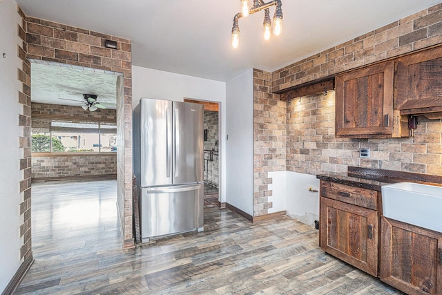 305 166th St, Calumet City, IL 60409 - kitchen with dark countertops, a ceiling fan, freestanding refrigerator, baseboards, and light wood-style flooring