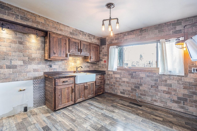 305 166th St, Calumet City, IL 60409 - kitchen featuring dark countertops, wood finished floors, visible vents, a sink, and hanging light fixtures