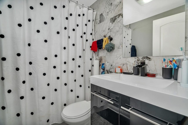 bathroom featuring toilet, tasteful backsplash, vanity, and tile walls
