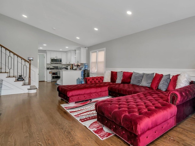 living room featuring vaulted ceiling, wood finished floors, and recessed lighting