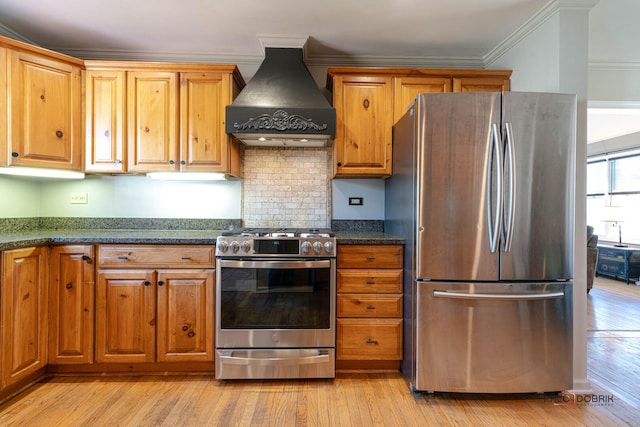kitchen featuring light wood-style flooring, custom exhaust hood, brown cabinets, crown molding, and appliances with stainless steel finishes