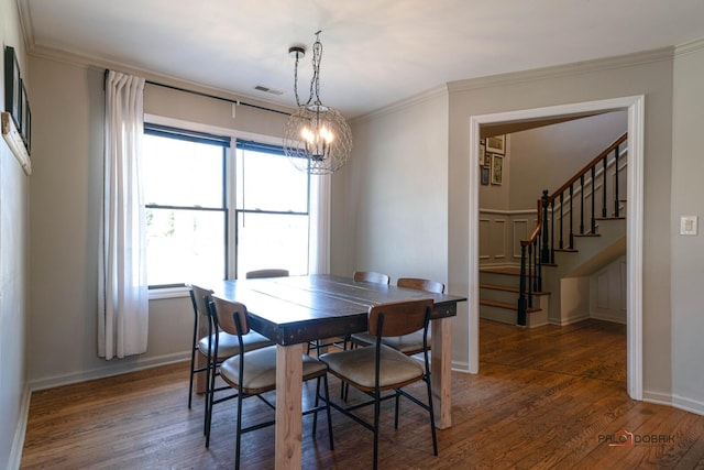 dining area featuring visible vents, baseboards, a chandelier, wood finished floors, and stairs