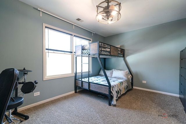 bedroom featuring baseboards, carpet flooring, and visible vents