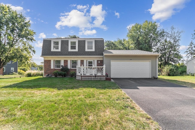 view of front of house with aphalt driveway, a front yard, brick siding, an attached garage, and a shingled roof