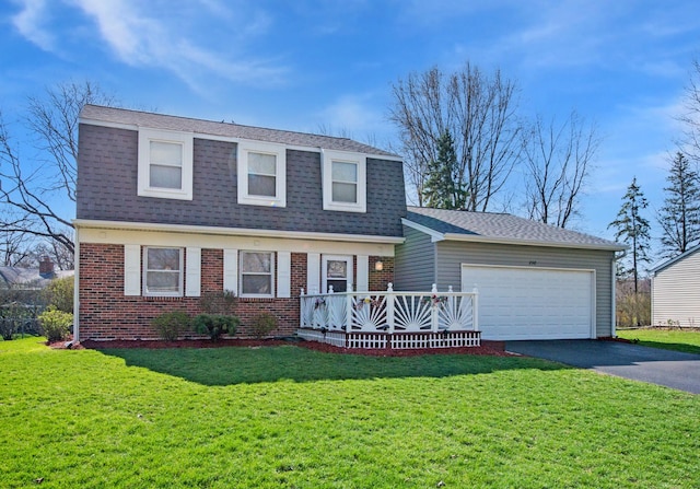 view of front of property with aphalt driveway, a front yard, brick siding, an attached garage, and a shingled roof