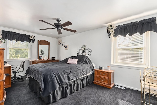 bedroom featuring visible vents, baseboards, and dark carpet